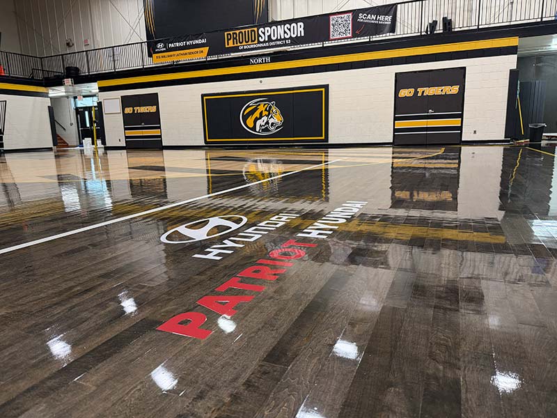 A gymnasium floor displays the Hyundai logo and Patriot Hyundai A gymnasium floor displays the Hyundai logo and Patriot Hyundai